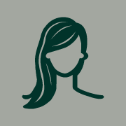 Icon of a person with long hair, depicted in a simplified, minimalist style. The figure has no facial features and is shown in dark green against a light gray background—perfect for representing the best hair salon Cary NC.