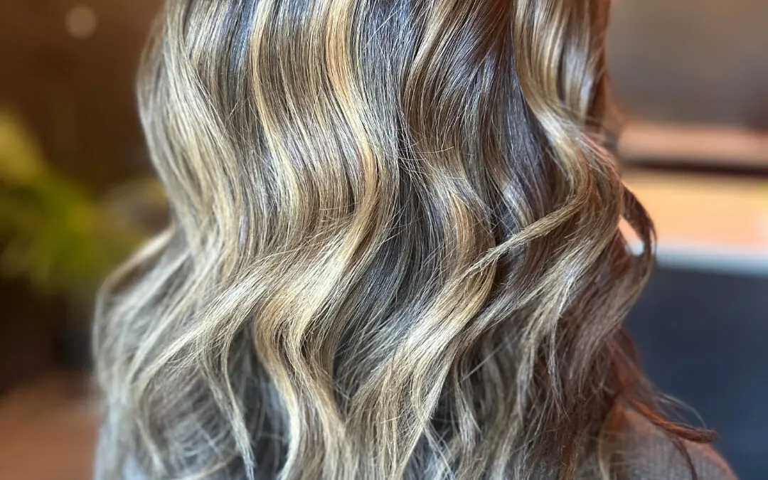 Transform your dark hair with a high-contrast golden blonde balayage and polished waves at Sunday Salon, Raleigh Iron Works. Book your custom color today!