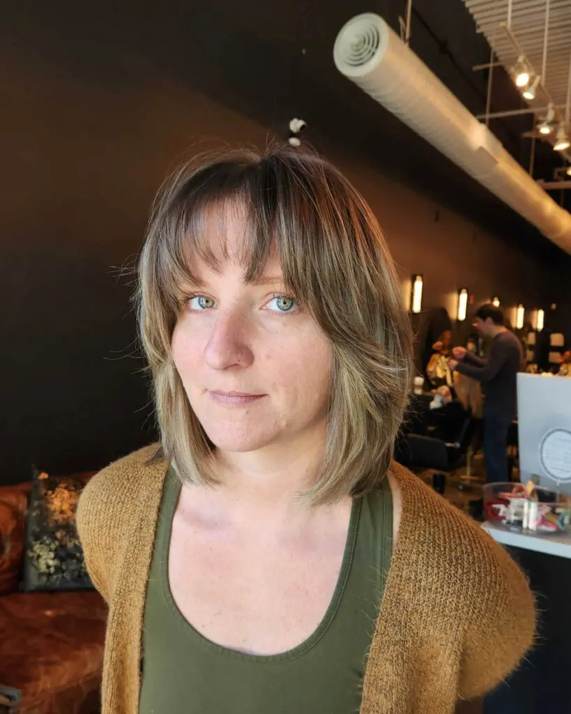 shoulder-length lob, wispy bangs, face-framing layers, textured haircut, Raleigh hair, downtown Raleigh salon