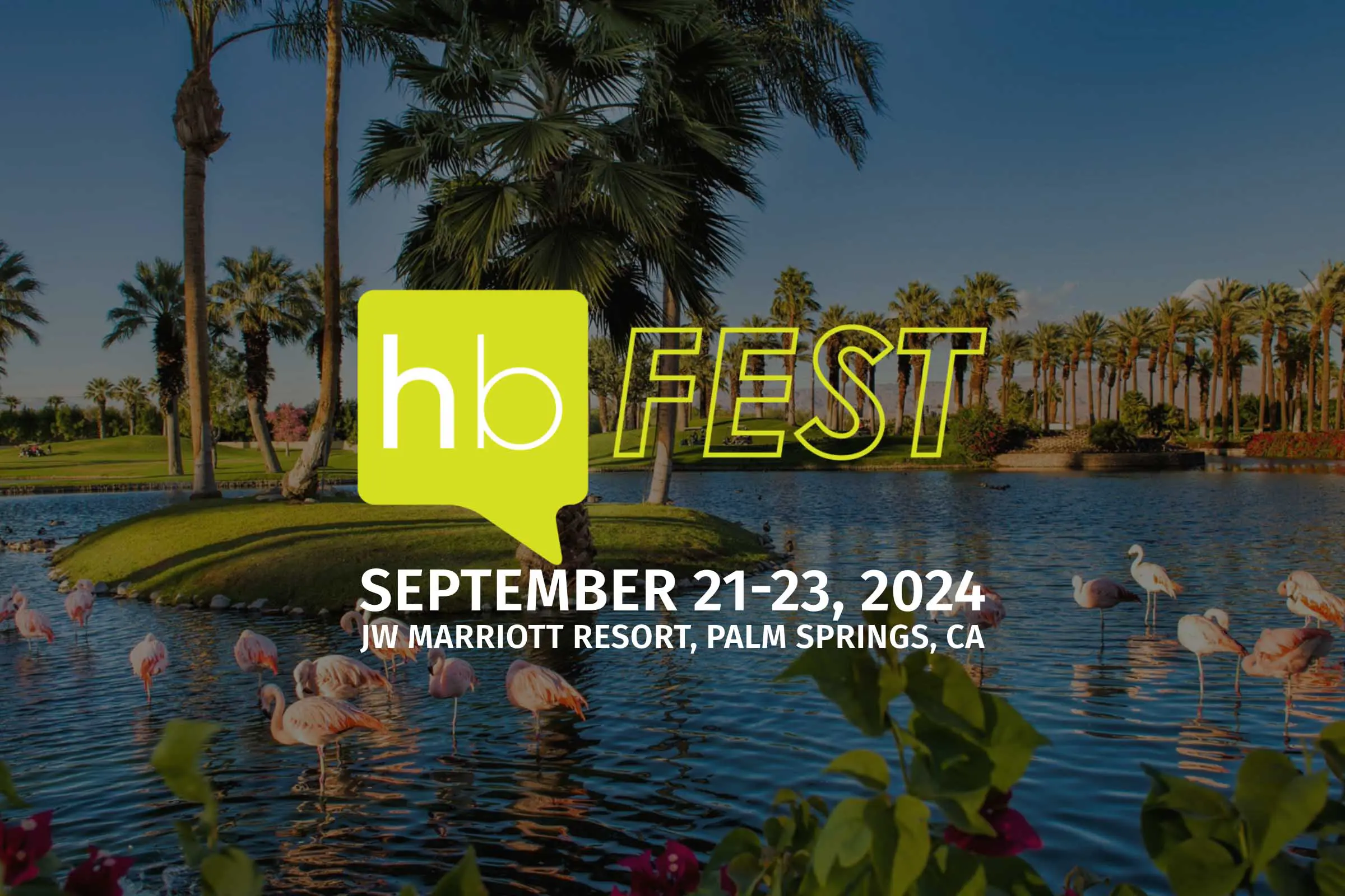 A scenic lake surrounded by palm trees with a small island in the middle. Flamingos dot the shore, adding a touch of elegance. Text overlay reads “hb FEST” and “SEPTEMBER 21-23, 2024 JW MARRIOTT RESORT, PALM SPRINGS, CA.” The background features a clear blue sky and distant mountains. Auto Draft vibes all around!