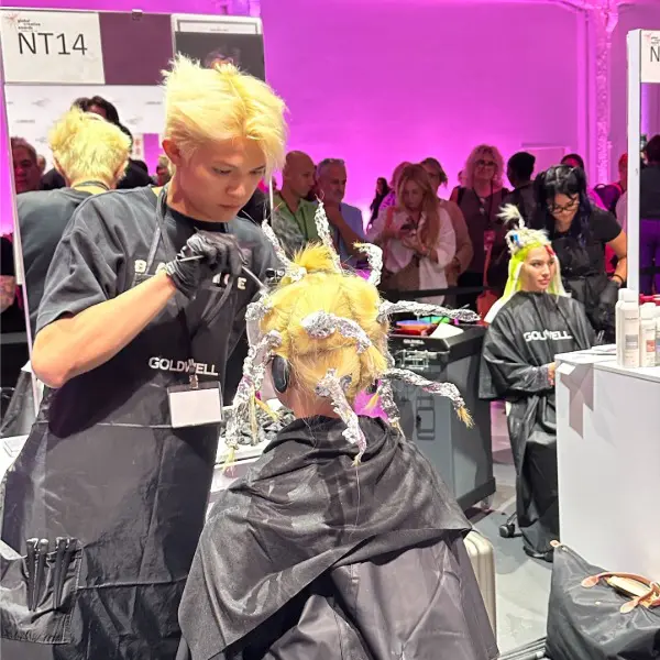 Behind the scenes: stylists in action during live color demonstrations. Behind the scenes: stylists in action during live color demonstrations.