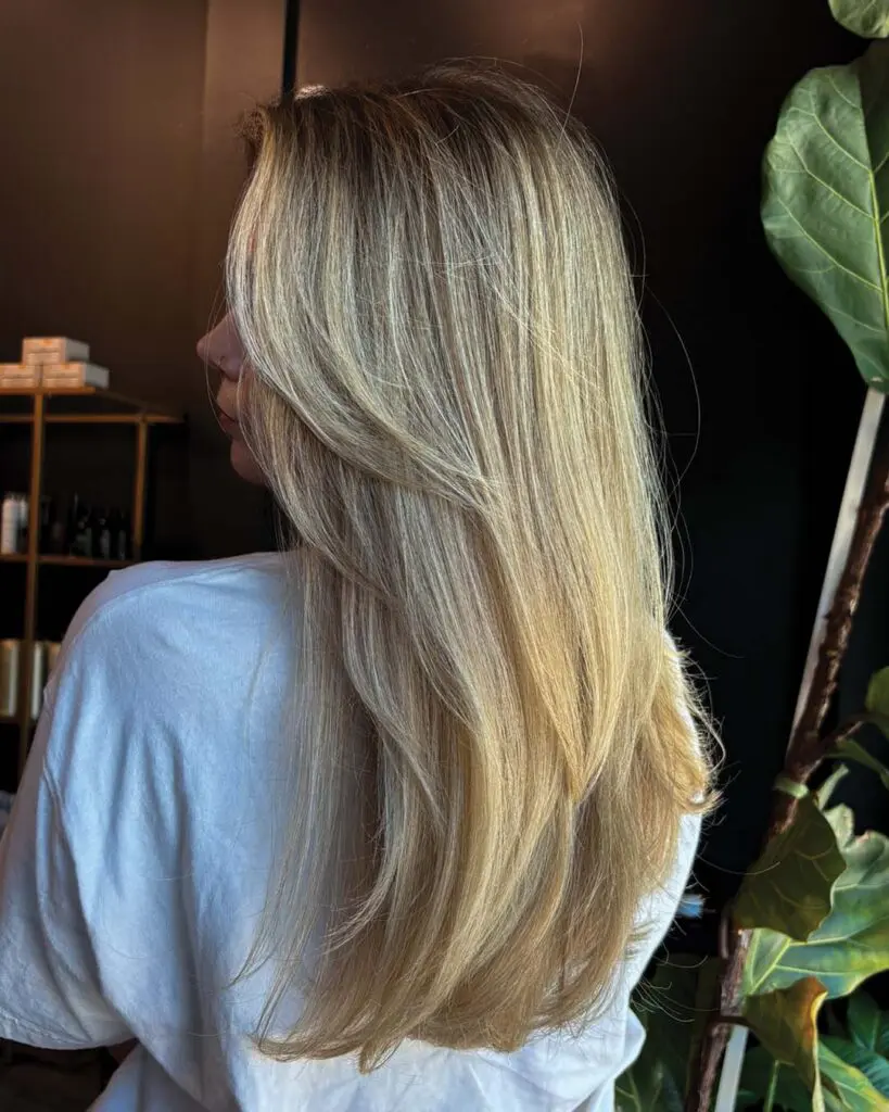 Long Creamy Blonde Balayage with Face-Framing Layers Long, sleek hair styled with beautiful face-framing layers and a bright, creamy blonde balayage, expertly crafted by a top stylist at Sunday Salon in Raleigh.