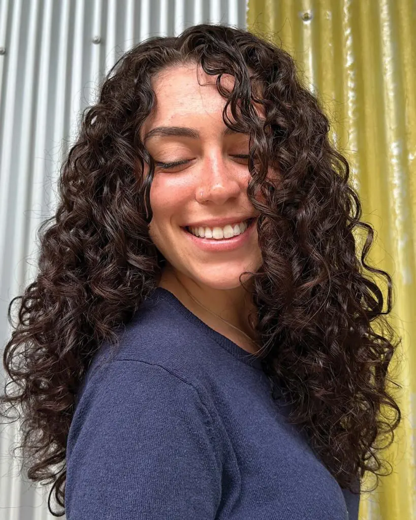 Deep Espresso Natural Curly Texture with Defined Cascading Ringlets A long, thick natural curly hair transformation with deep espresso brunette tones, defined bouncy ringlets, and high-shine gloss created at Sunday Salon in Raleigh.