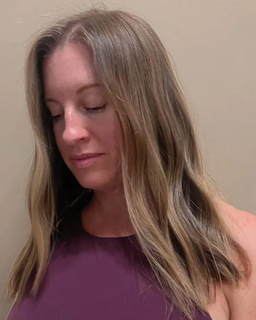 Lived-In Ash Blonde Sombre with Effortless Soft Waves A medium-to-long ash blonde hair transformation created at Sunday Salon in Raleigh, featuring low-maintenance dimensional sombre tones and soft, relaxed waves.