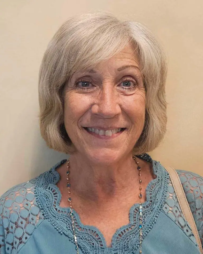 Chin-length platinum blonde bob featuring internal texture and side-swept fringe, expertly styled at Sunday Salon located in Raleigh.